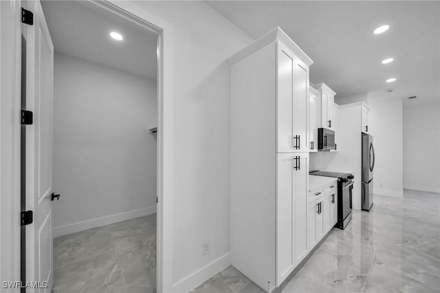 kitchen with white cabinetry and appliances with stainless steel finishes