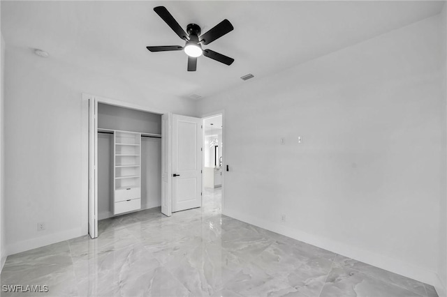 unfurnished bedroom with ceiling fan and a closet