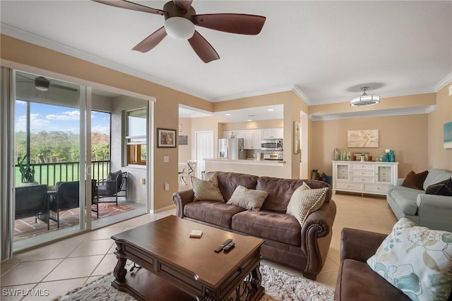 living room featuring light tile patterned floors, ceiling fan, and crown molding