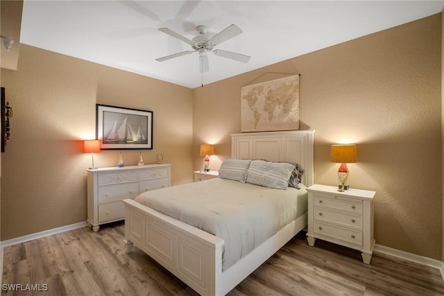 bedroom with ceiling fan and light wood-type flooring