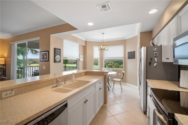 kitchen featuring sink, white cabinets, pendant lighting, and appliances with stainless steel finishes