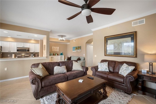 tiled living room featuring ceiling fan and crown molding