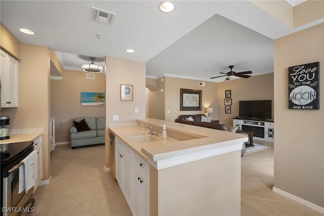 kitchen featuring electric stove, sink, ceiling fan, light tile patterned flooring, and white cabinetry