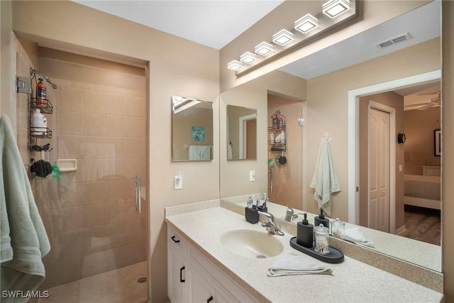 bathroom featuring a tile shower and vanity