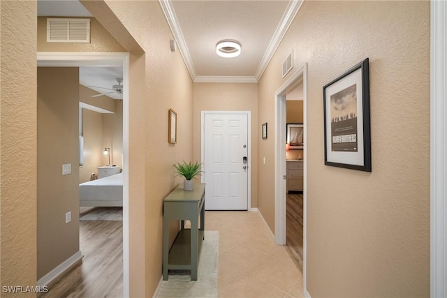 hall featuring light hardwood / wood-style floors and ornamental molding