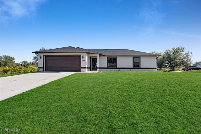 view of front facade with a garage and a front lawn