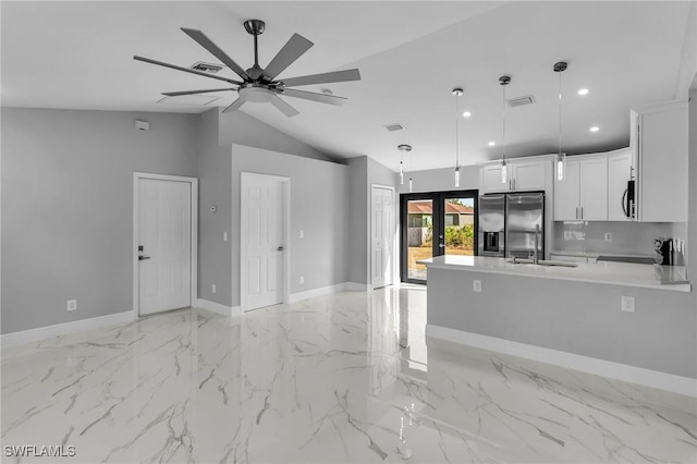 kitchen featuring stainless steel fridge, french doors, sink, decorative light fixtures, and white cabinetry