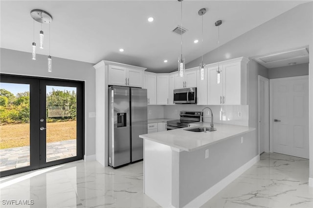 kitchen featuring white cabinetry, sink, french doors, hanging light fixtures, and appliances with stainless steel finishes