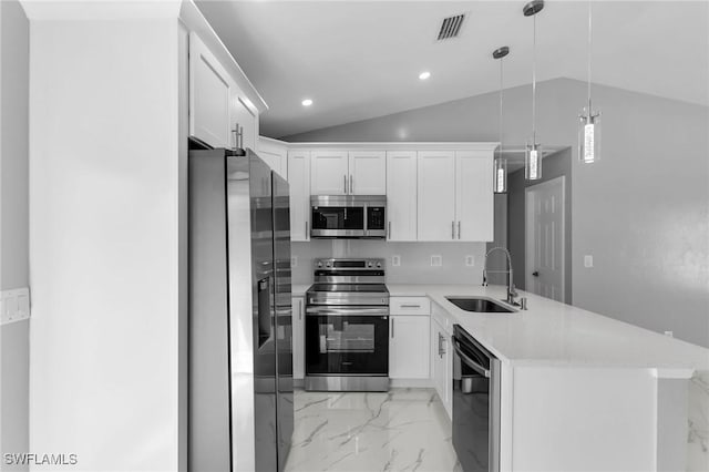 kitchen featuring white cabinetry, sink, hanging light fixtures, and appliances with stainless steel finishes