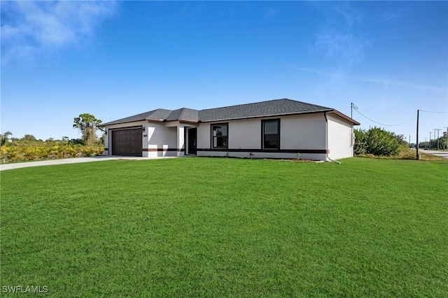 view of front of house with a front yard and a garage