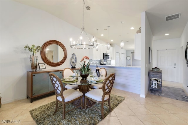 tiled dining room featuring a notable chandelier