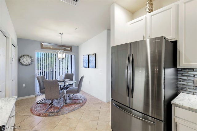 tiled dining space featuring an inviting chandelier