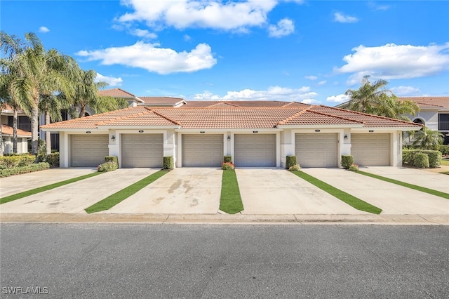 10296 Heritage Bay Blvd Unit 3124, Naples, FL 34120 - view of front of house featuring stucco siding, community garages, and a tiled roof
