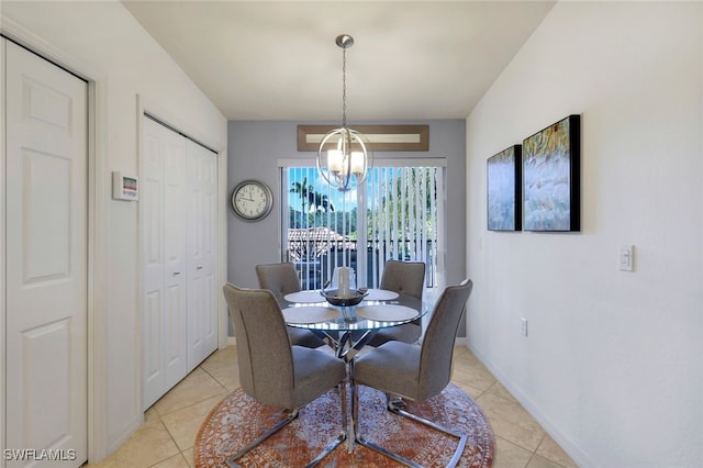 dining room with light tile patterned floors and a notable chandelier