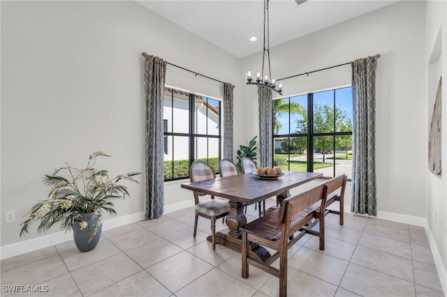 dining area featuring light tile patterned flooring and a chandelier