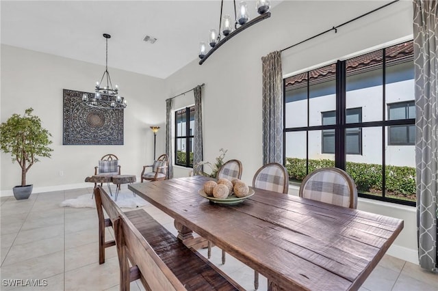 dining area featuring light tile patterned floors and a chandelier