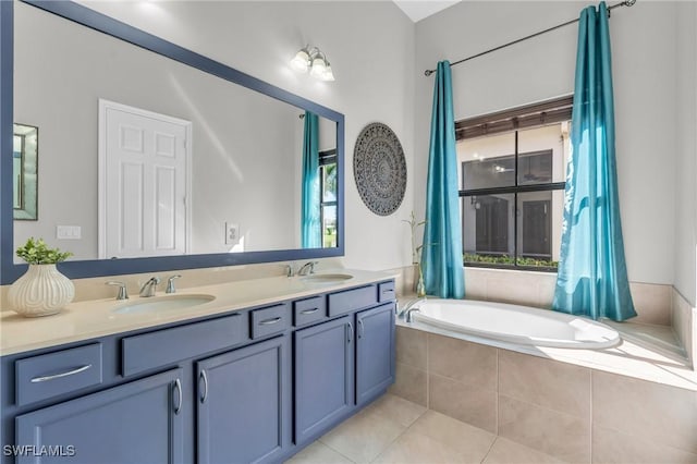 bathroom featuring a relaxing tiled tub, vanity, and tile patterned flooring