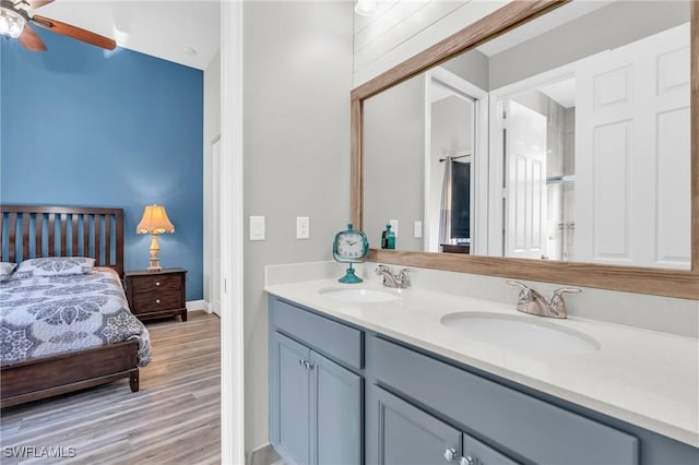 bathroom with ceiling fan, hardwood / wood-style floors, and vanity