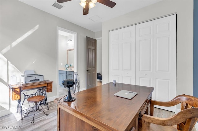 office with ceiling fan and light hardwood / wood-style floors