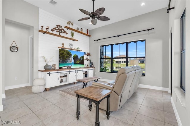 living room with ceiling fan and light tile patterned flooring