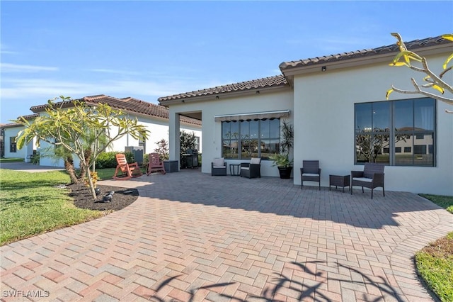 back of property featuring an outdoor living space and a patio