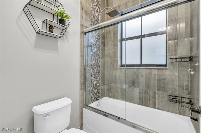 bathroom featuring toilet and enclosed tub / shower combo