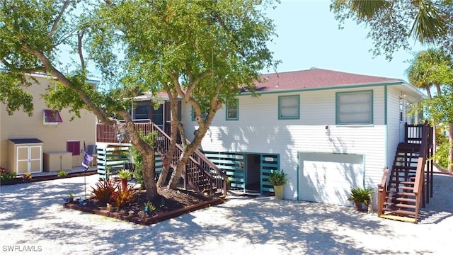 view of front of house with a garage and stairway