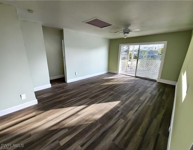 spare room featuring dark wood finished floors, baseboards, and ceiling fan