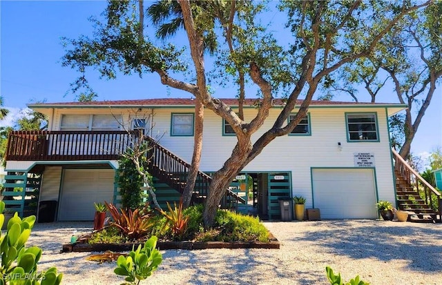 view of front of property featuring a garage and stairway