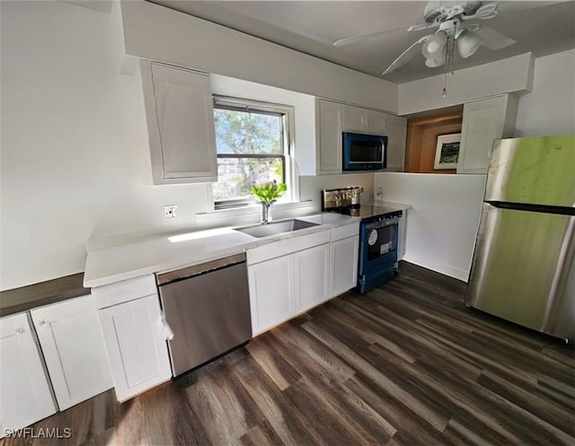 kitchen with electric range oven, freestanding refrigerator, white cabinets, a sink, and dishwasher