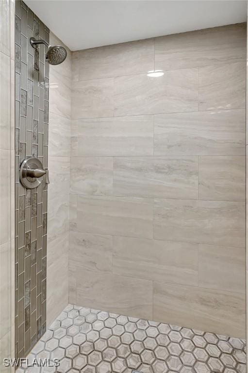 bathroom with tiled shower