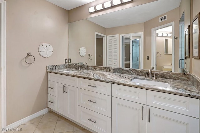 bathroom with tile patterned floors, vanity, and toilet