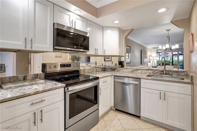 kitchen featuring an inviting chandelier, crown molding, sink, white cabinetry, and stainless steel appliances