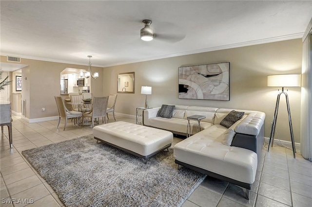 living room featuring ceiling fan with notable chandelier, light tile patterned floors, and ornamental molding