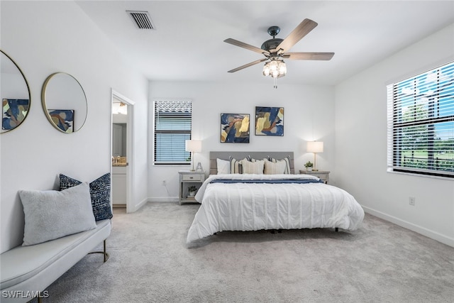 carpeted bedroom featuring visible vents, ceiling fan, and baseboards