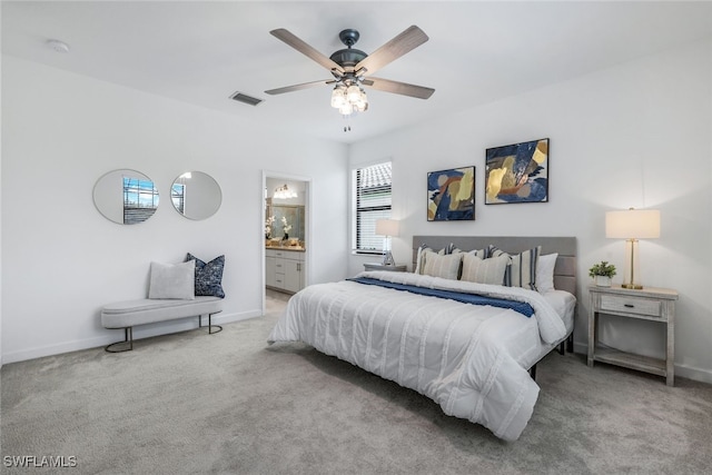 bedroom featuring ensuite bathroom, carpet, visible vents, and baseboards