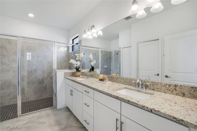 full bathroom with a sink, a shower stall, and visible vents