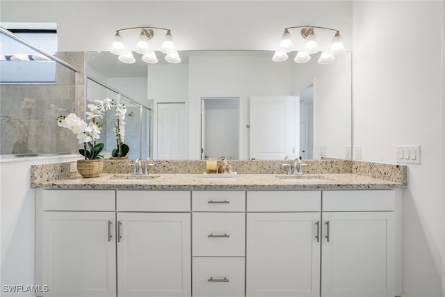 bathroom featuring double vanity, a shower stall, and a sink