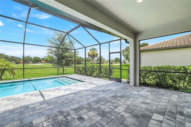 view of swimming pool with a lawn, a patio area, and a lanai