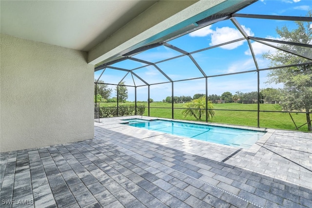 outdoor pool featuring glass enclosure, a lawn, and a patio