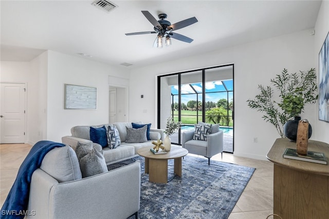 living area featuring light tile patterned floors, visible vents, a sunroom, ceiling fan, and baseboards