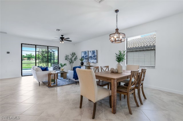 dining area featuring light tile patterned floors, ceiling fan, visible vents, and baseboards