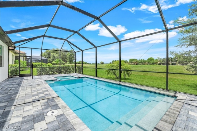 view of pool featuring a yard, a patio, a lanai, and a pool with connected hot tub