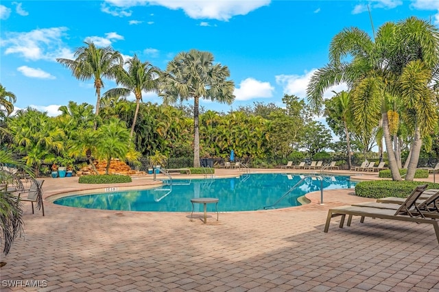 community pool featuring a patio area and fence