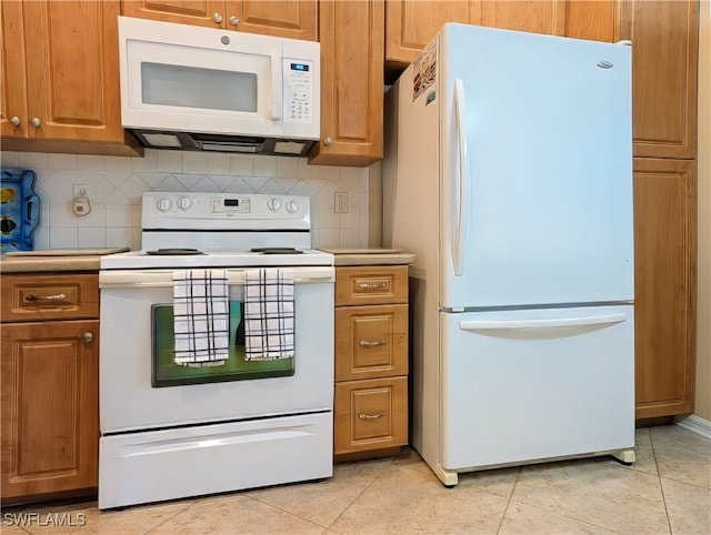 kitchen with white appliances, backsplash, and light tile patterned floors