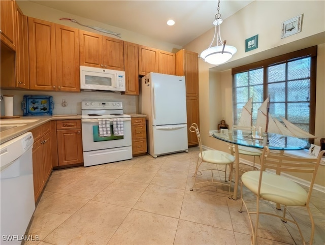 kitchen featuring light tile patterned floors, white appliances, and pendant lighting