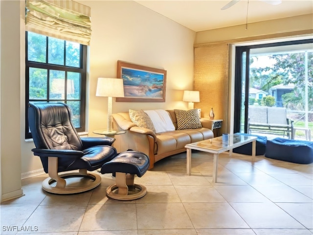 sitting room with ceiling fan and tile patterned flooring