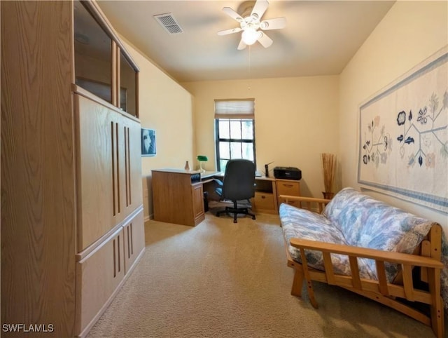 carpeted office space featuring ceiling fan