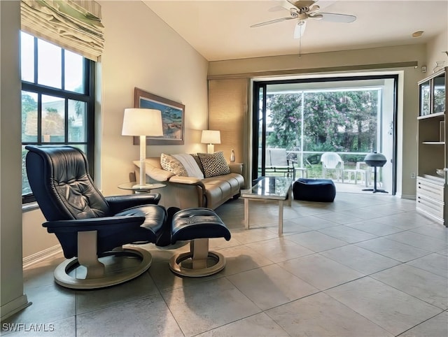 living area featuring ceiling fan and light tile patterned floors