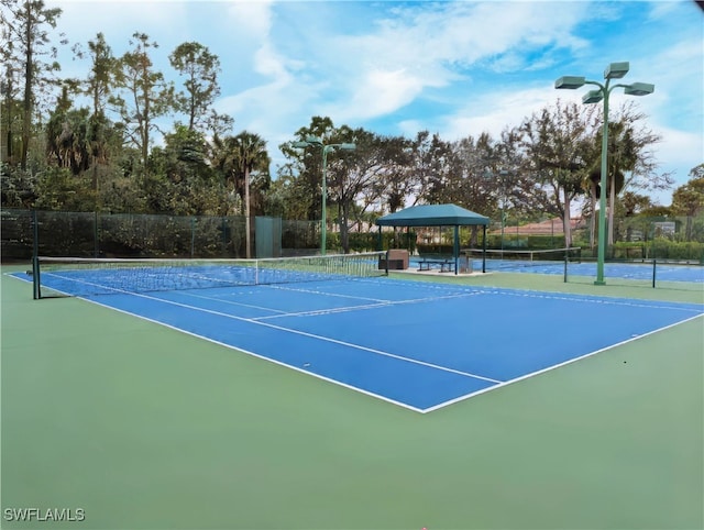 view of sport court with basketball hoop